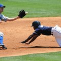 Northwest Arkansas’ Derrick Robinson, right, slides into second base as Tulsa’s Erik Wetzel catches ...