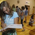 SCHOOL’S OUT Camryn Holly, 10, signs a friend’s yearbook Thursday during a signing party for the fou...