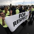 Guillermo Ruiz of Dallas holds a sign Thursday as members of the groups Making Change at Walmart and...