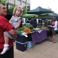 KIDS DAY Bob Roten holds his granddaughter, Faith Roten, 4, on Thursday at the Fayetteville Farmers’...