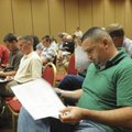Louie Dajani of Cabot looks over paperwork during the land auction Thursday.
