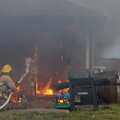  KITCHEN FIRE A Lowell firefighter battles a blaze Thursday at 1330-B Dove Loop in Bethel Heights. M...