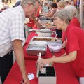  Doug Bearden talks with Sharon Rothrock before making his way down the serving line June 12 during ...