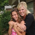 Beth Main hugs her daughter Kayla, 13, at their Springdale home. Main, a nurse, is a single mom in ...