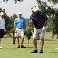  Arthur Baldwin, from right, celebrates a made putt as his son Aaron Baldwin and brother Ken Baldwin...