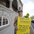  Sharon Davison of Fayetteville protests on Saturday during the filming of former circuit judge Mary...