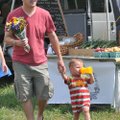 Ross Jorski and his son Michael, both from Rogers, walk through the Fayetteville Farmers Market at t...