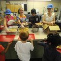 Natasha Johnson, left, Shelby Wells, Antonio Juarez and Summer Hart serve fellow campers lunch Frida...