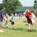 Former Razorback Norman Nero, left, teaches speed and agility exercises to a group of fourth- throug...