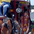 Keith Douglas, 7, left, and Olivia Holloway, 6, look out the window of a stagecoach Monday during th...