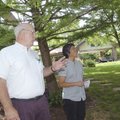 Orlo Stitt shows Karen Takemoto of Arkansas Interfaith Power & Light how shade trees make the Stitt ...