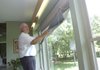 Orlo Stitt demonstrates the two-shade system that helps keep his home cool during summer and warm in winter. The Stitts will open their home for a “green energy” scavenger hunt Sunday to benefit Arkansas Interfaith Power & Light.