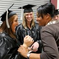 Robin Eason, right, surgical technology instructor, laughs with Lobat Siahmakoun, left, and Katie Ru...