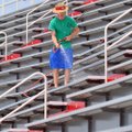 Spencer Spears washes bleachers Wednesday at Reynolds Razorback Stadium. The Arkansas High School Co...