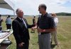 Ray Boudreaux, director of the Fayetteville Executive Airport, left, talks with Jerry Chism, assistant director of the Arkansas department of aeronautics, after a dedication Wednesday of the airport’s completion of the Runway 16 Safety Area Project at the airport in Fayetteville. The project included adding safety areas of 1,000 feet past the runway end at a width of 500 feet. Plans for the project started in 2005 with a $4 million grant.