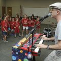 Chris “Boom!” Wiser sings to patrons of the Rogers Public Library on Wedneday during a performance o...