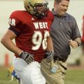  Trainer Jonathan Elrod of Arkadelphia runs off the field with Dirk Tanner after Tanner of Pulaski A...