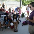  Elizabeth Kennedy, 15, of Bella Vista, right, speaks Thursday to the tennis players taking part in ...