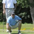  Craig Whited, below, and Randy Mertes, both with the Scotts Company, line up a putt on Friday, June...