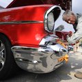  Bill Long shines the front end of a newly-restored 1957 Chevy Bel Air owned by Peggy Townsend of Gr...