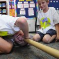  David Wallace, 7, left, looks for a lost marble as Matthew Carddock, 7, looks on during Camp Invent...