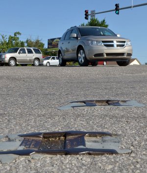 A couple of old metal plowable pavement markers sit at the corner of East Randall Wobbe Lane and North Thompson Street in Springdale.