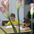 Tyler Gilliam and his brother, Brett Gilliam (right), work on a drawing exercise Monday during a Dra...