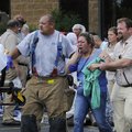 An employee at the Tyson Plant on Berry Street in Springdale is helped by another employee and emerg...