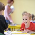 James Marshall, 6, right, smiles Tuesday as Elliot Hansford, 7, both of Fayetteville helps him compl...