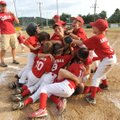 Members of the McAlister Dental Clinic Drillers celebrate their win Tuesday over the Friendly Bulldo...