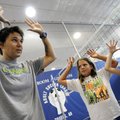 Andrea Brinton, left, a former professional beach volleyball player, demonstrates the proper setting...