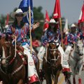Chera Phillips of Huntsville, captain of the Sky High Angels Drill Team, waves to the crowd Wednesda...