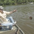 Jim Hall of Fayetteville swings one of 60 bluegill he caught with his fly rod at Lake Fayetteville o...