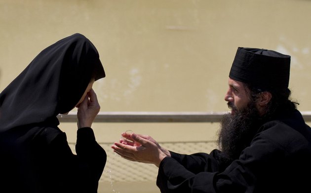 orthodox-christian-clergy-at-the-baptismal-site-of-qasr-el-yahud-the-spot-where-john-the-baptist-is-said-to-have-baptized-jesus-near-the-west-bank-town-of-jericho-tuesday-july-12-2011
