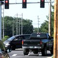 A truck turns right Tuesday on a solid red arrow from Elm Tree Road to Southwest 14th Street in Bent...