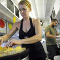 Paula Jo Chitty Henry, left, adds fresh ingredients to a buckwheat crepe July 13, while preparing or...