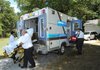 Central Emergency Medical Service medic Melissa Mitchell, right, loads equipment into a CEMS ambulance as EMTs Josh Harrison, left, and Brian Rairdon help load a patient Friday, July 8, 2011, on East Huntsville Road in Fayetteville. Officials with Washington County, Fayetteville and eight smaller cities have until Sept. 1 to rework the interlocal agreement that made CEMS their exlusive provider of ambulance services in 2008. If they take no action, the agreement will be renewed for an additional five years.
