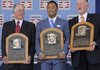 Former Golden Glove second baseman Roberto Alomar (center), former pitcher Bert Blyleven (right) and baseball executive Pat Gillick show off their plaques after their induction into the Baseball Hall of Fame in Cooperstown, N.Y., on Sunday. 