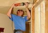 Eric Moore from Janacek Construction works Tuesday to enlarge an opening into a kitchen during renovation work at 11173 Talamore Blvd. in Bentonville. A remodeler license is now required by the state for renovations exceeding $2,000.