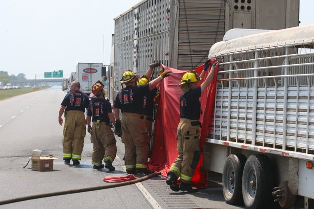 north-little-rock-firefighters-erect-a-large-tarp-as-they-prepare-to-remove-dead-cattle-from-a-tractor-trailer-rig-which-caught-fire-along-westbound-i-40-east-of-i-440-monday-afternoon-in-north-little-rock