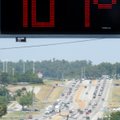 A sign displays the expected high temperature Tuesday as traffic passes along North College Avenue i...