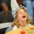 Lana Glenn, 3, of Elkins laughs Tuesday while trying food and tea during the Fayetteville Public Lib...