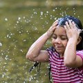 Gloria Diaz, 6, cools off in Prairie Creek on Tuesday during a late afternoon visit with her family ...