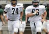 Bentonville offensive tackle Bo Weber, left, and center Alex Westermeyer run sprints Thursday, Aug. 4, 2011, during the Tigers' practice at Tiger Stadium in Bentonville.
