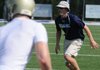 Shiloh Christian assistant coach Austin Tucker helps with drills at practice on Aug. 2 at Champions Stadium in Springdale.