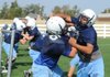 Springdale Har-Ber lineman senior JC Bond, left, and junior Miguel Ceballos work on blocking during practice Monday at the school’s practice field.