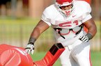   University of Arkansas Razorbacks defensive tackle Alfred Davis runs drills during practice Monday afternoon on the intramural fields at the University of Arkansas in Fayetteville. 