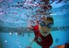 Baran Vural plunges under the water during swim class July 12 at The Little Rock Athletic Club. 