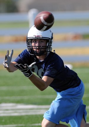 Springdale Har-Ber junior wide receiver Austin Pierce goes through route and catching drills at practice Monday at the school’s practice field.