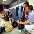 Roberto Garcia holds his son, Gael Garcia, 6, on Gael’s first day of first grade Monday at Holcomb E...